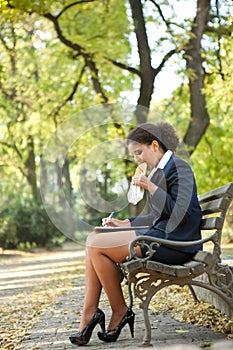 Businesswoman having breakfast in the park