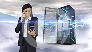 Businesswoman having phone call and holding tablet computer in front of server tower