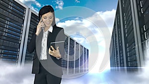 Businesswoman having phone call and holding tablet computer in server tower store