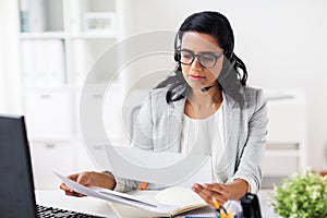 Businesswoman with headset and computer at office