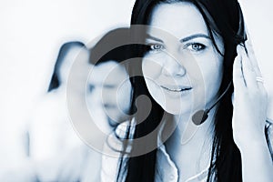 Businesswoman with headset smiling in call center
