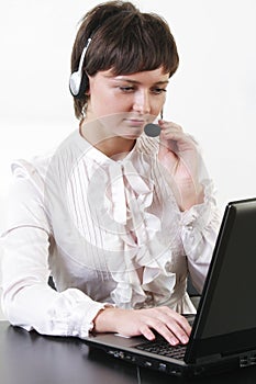 Businesswoman with headset working at computer