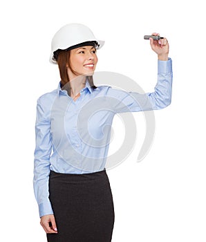 Businesswoman in helmet writing on virtual screen