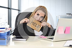 Businesswoman in her 40s holding help sign desparate suffering stress overworked