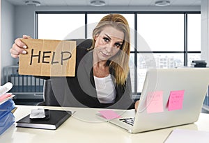 Businesswoman in her 40s holding help sign desparate suffering stress overworked