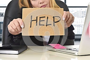 Businesswoman in her 40s holding help sign desparate suffering stress overworked