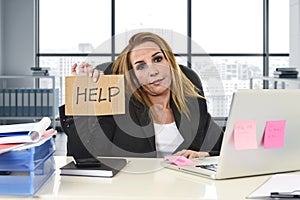 Businesswoman in her 40s holding help sign desparate suffering stress overworked