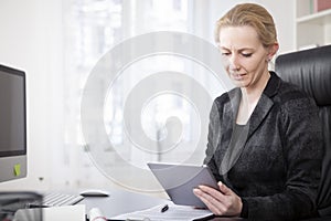 Businesswoman at her Office Using Tablet Computer