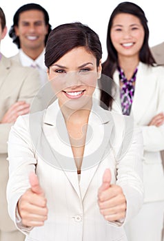 Businesswoman and her team with thumbs up