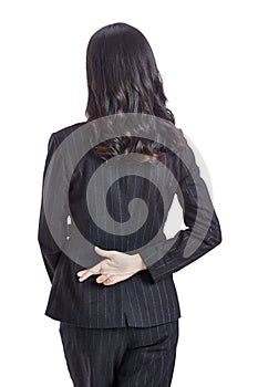 Businesswoman hiding a good luck sign behind back