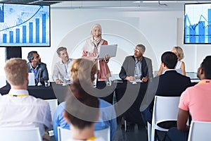 Businesswoman in hijab giving presentation at table
