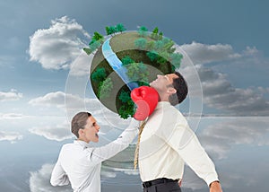 Businesswoman hitting a businessman with boxing gloves