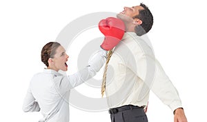 Businesswoman hitting a businessman with boxing gloves