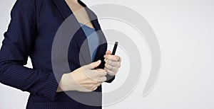 Businesswoman hold black pen on white background, closeup. Closeup of hand holding a black marker