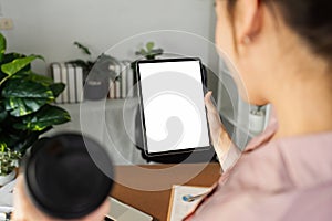 businesswoman hold mockup digital tablet with blank screen Mockup replace your design mockup in the office