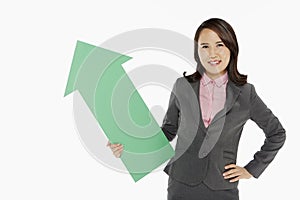 Businesswoman holding an arrow, pointing upwards