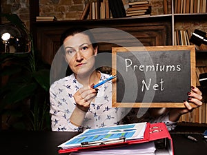 Businesswoman holding a black chalkboard. Business concept about Premiums Net with phrase on the sheet