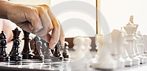 A businesswoman holding a black chess piece walks forward on a chessboard, comparing the chessboard to business administration.