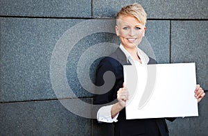 Businesswoman holding blank white sign