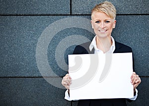 Businesswoman holding blank white sign