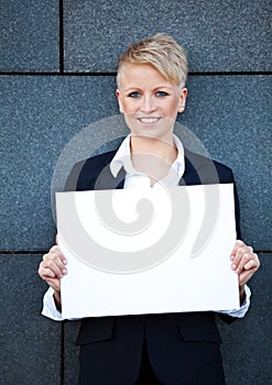 Businesswoman holding blank white sign