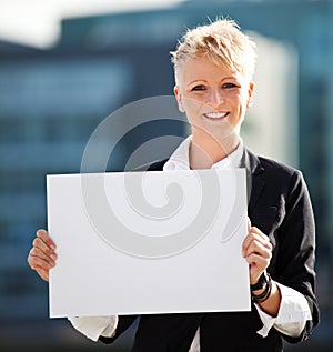 Businesswoman holding blank white sign