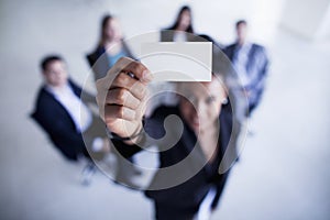 Businesswoman holding a business card up to the camera- Shannon Fagan Photography