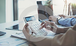 Businesswoman holding calculator for calculate financial data at meeting room, Business Financing Accounting Banking Concept