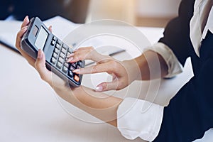 Businesswoman holding calculator for calculate number and discus