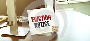 Businesswoman holding a card with text eviction notice