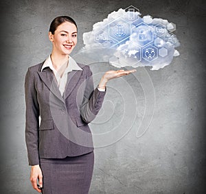 Businesswoman holding cloud with different digital icons.