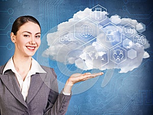 Businesswoman holding cloud with different digital icons.