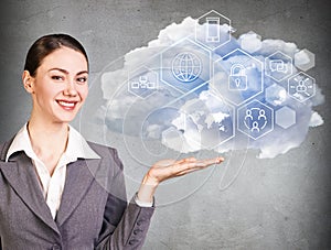 Businesswoman holding cloud with different digital icons.