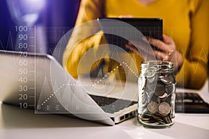 Businesswoman holding coins putting in glass with using smartphone and calculator to calculate  concept saving money for finance