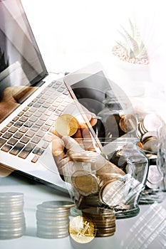 businesswoman holding coins putting in glass with using smartphone and calculator to calculate concept saving money for finance