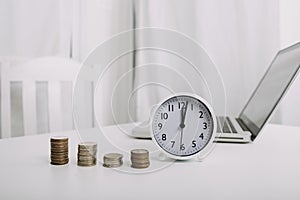 Businesswoman holding coins putting in glass with using smartphone and calculator to calculate concept saving money for finance ac