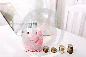 Businesswoman holding coins putting in glass with using smartphone and calculator to calculate concept saving money for finance ac