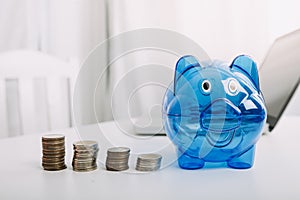 Businesswoman holding coins putting in glass with using smartphone and calculator to calculate concept saving money for finance ac