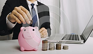 Businesswoman holding coins putting in glass with using smartphone and calculator to calculate concept saving money for finance ac