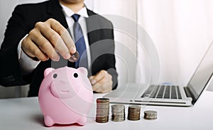 Businesswoman holding coins putting in glass with using smartphone and calculator to calculate concept saving money for finance ac