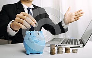 Businesswoman holding coins putting in glass with using smartphone and calculator to calculate concept saving money for finance ac