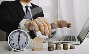 Businesswoman holding coins putting in glass with using smartphone and calculator to calculate concept saving money for finance ac