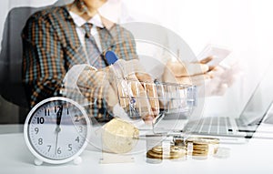 Businesswoman holding coins putting in glass with using smartphone and calculator to calculate concept saving money for finance ac