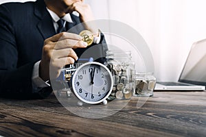 Businesswoman holding coins putting in glass with using smartphone and calculator to calculate concept saving money for finance ac