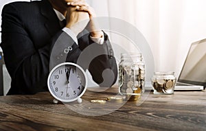 Businesswoman holding coins putting in glass with using smartphone and calculator to calculate concept saving money for finance ac