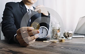 Businesswoman holding coins putting in glass with using smartphone and calculator to calculate concept saving money for finance ac