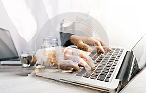 Businesswoman holding coins putting in glass with using smartphone and calculator to calculate concept saving money for finance ac