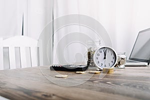 Businesswoman holding coins putting in glass with using smartphone and calculator to calculate concept saving money for finance ac