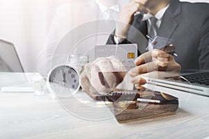 Businesswoman holding coins putting in glass with using smartphone and calculator to calculate concept saving money for finance ac