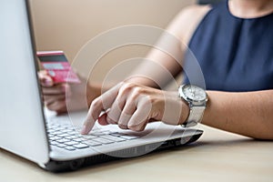 Businesswoman holding credit card for online shopping while making orders via the Internet. business, technology, ecommerce and